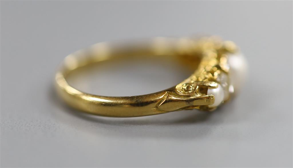 An Edwardian yellow metal, split pearl and diamond set half hoop ring, size N, gross 3.6 grams.